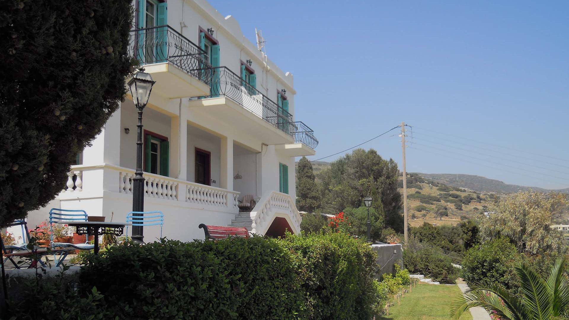 a white building with a green roof