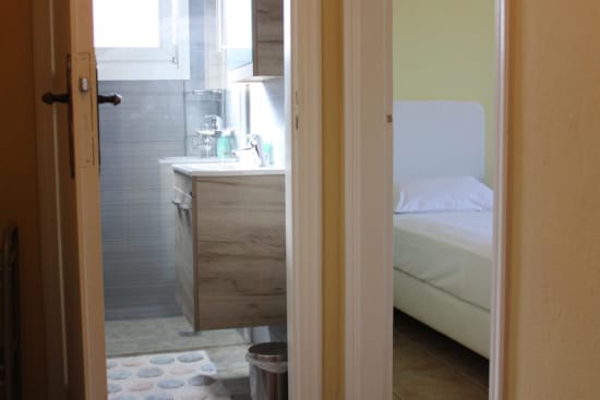 a bathroom with a sink and a bed