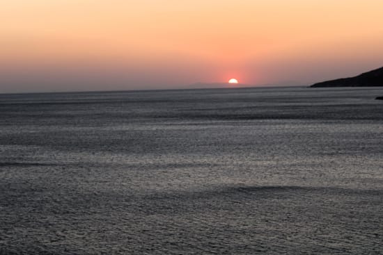 a sunset over a body of water