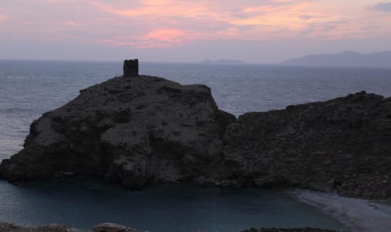 a rocky cliff with a lighthouse