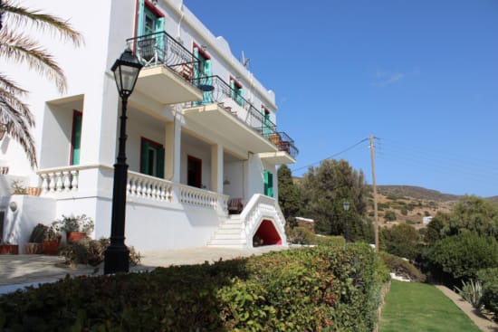 a white house with a green lawn