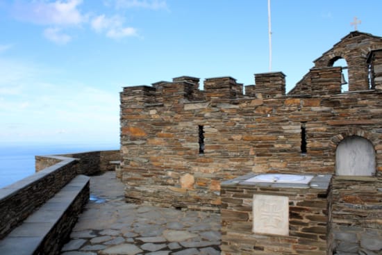 a stone building with a cross on top