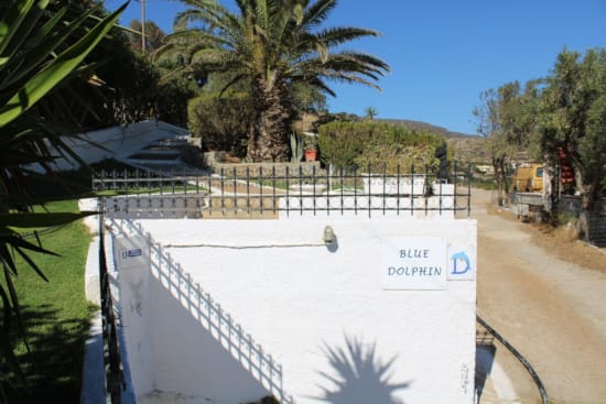 a white fence with a sign on it