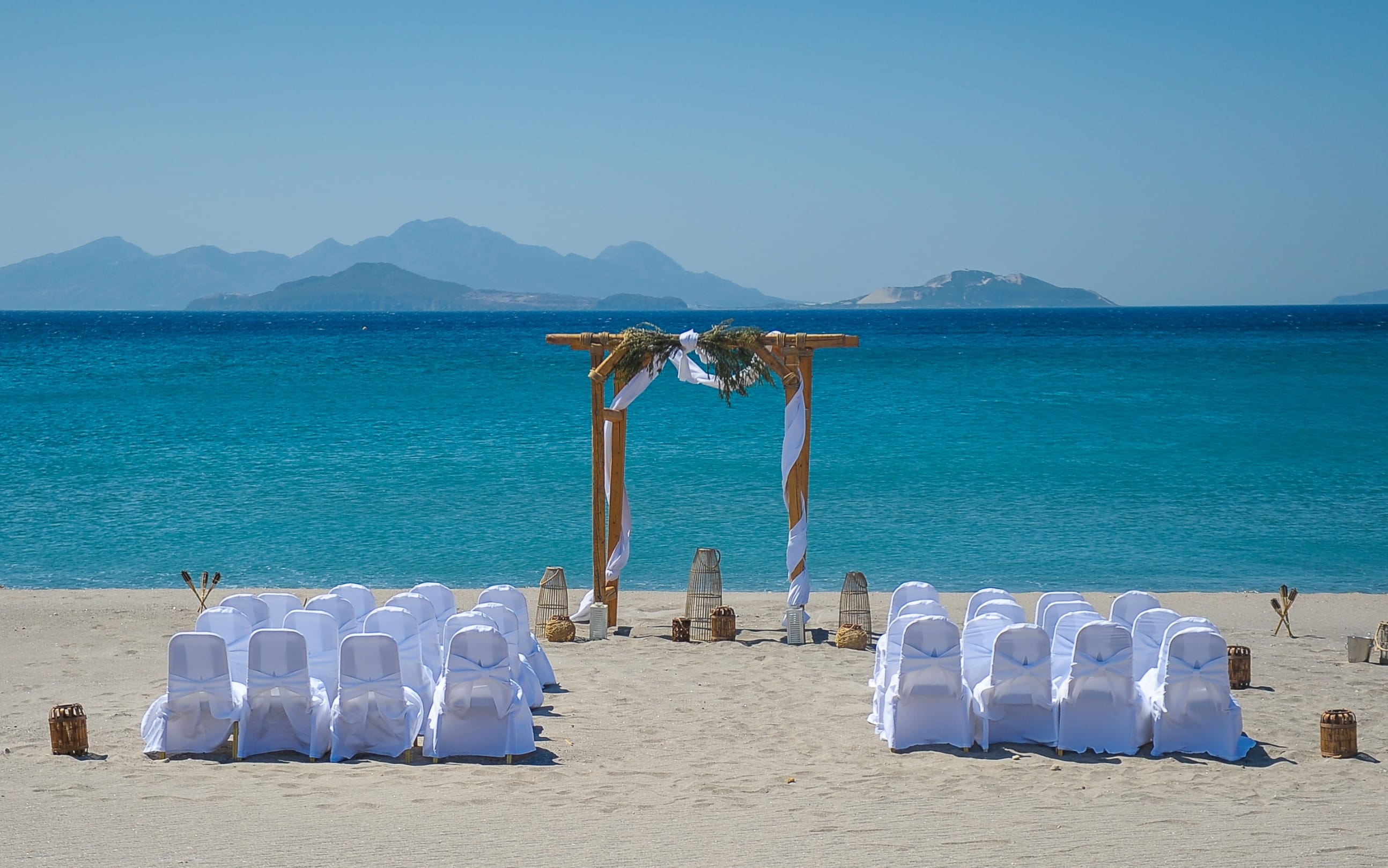a beach with sand and chairs