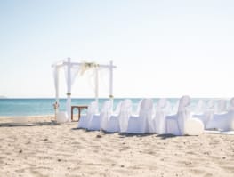 a row of chairs on a beach