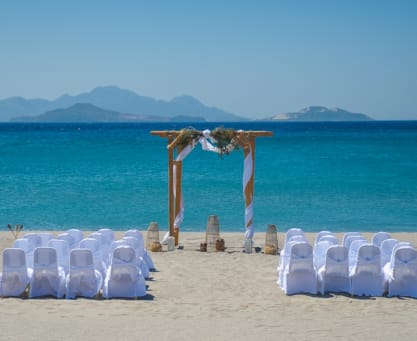 a beach with sand and chairs