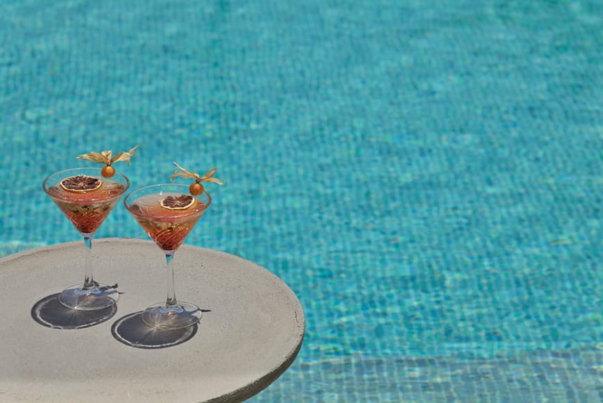 two glasses of drinks on a table