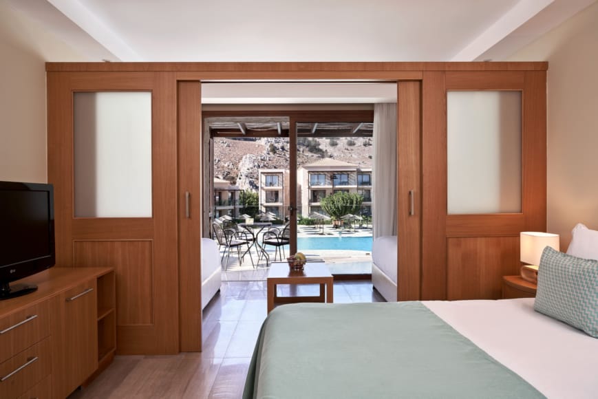 a bedroom with a large glass door
