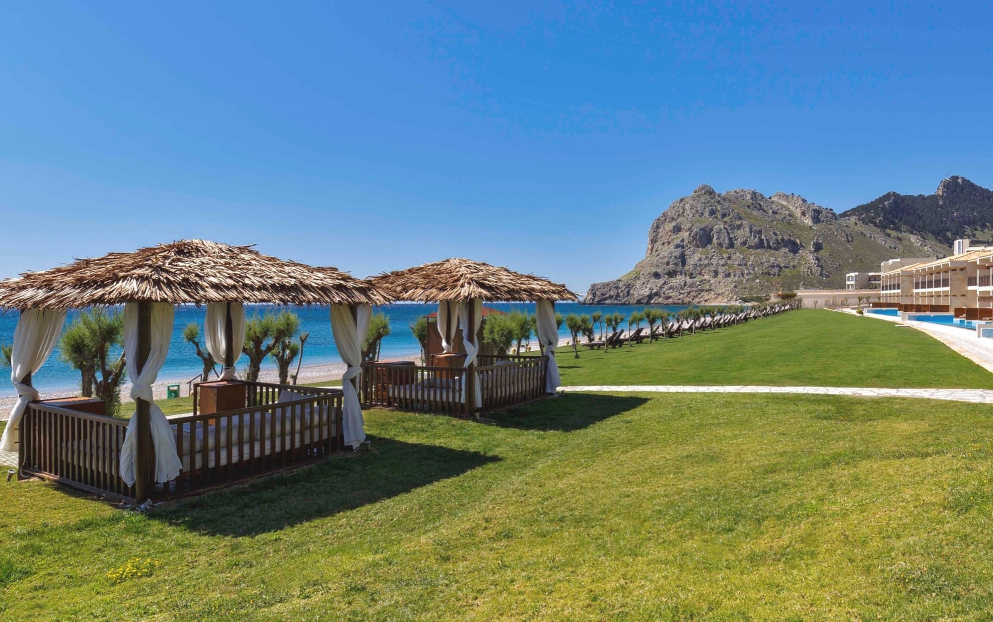 a golf course with straw umbrellas