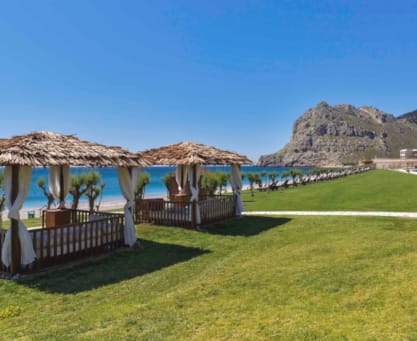 a golf course with straw umbrellas