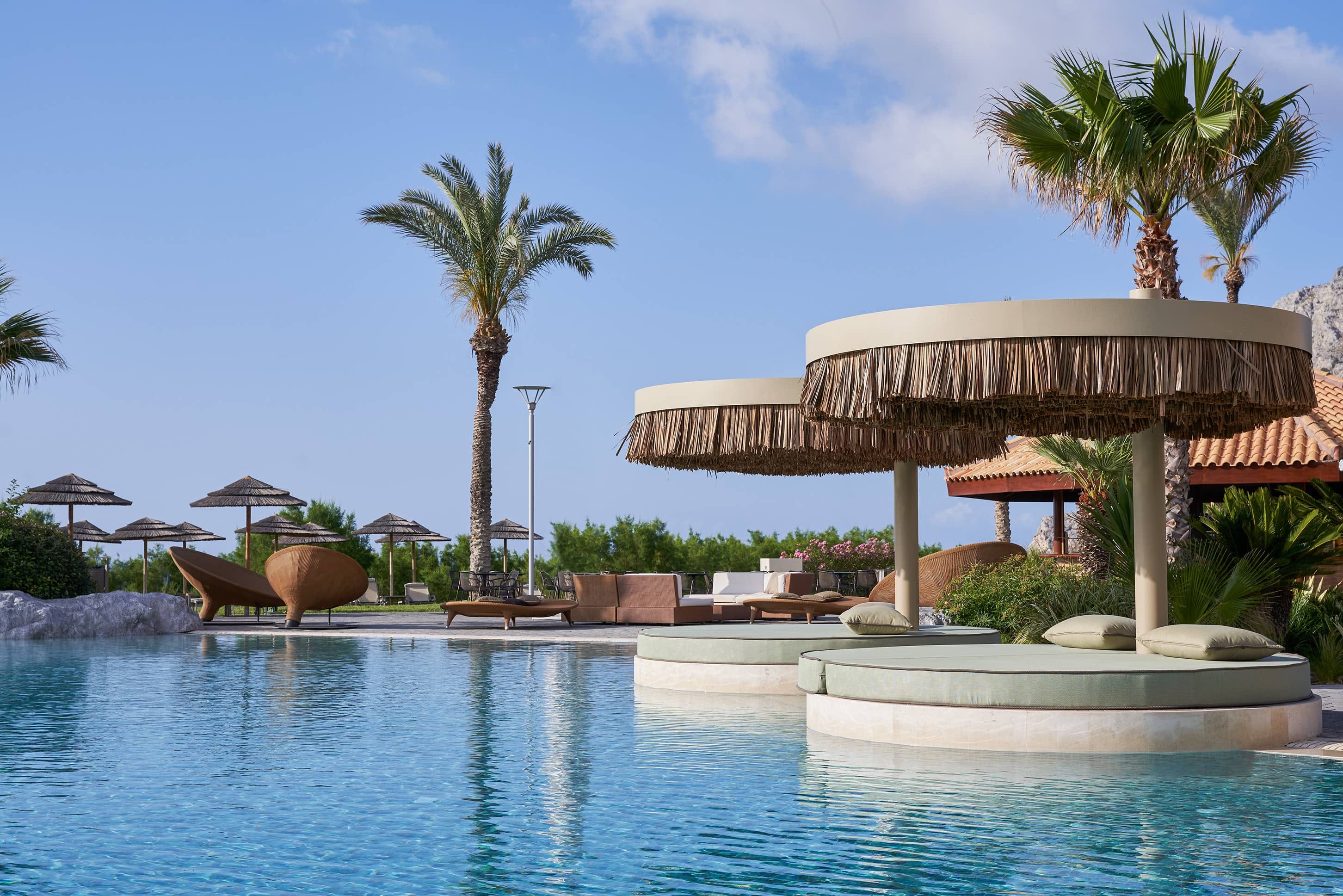 a pool with umbrellas and chairs by it