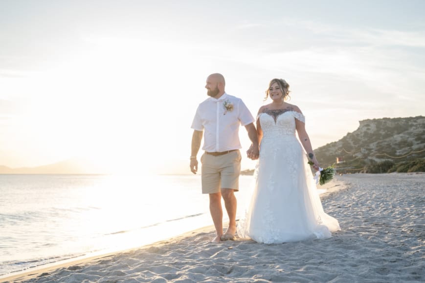 a man and woman walking on a beach