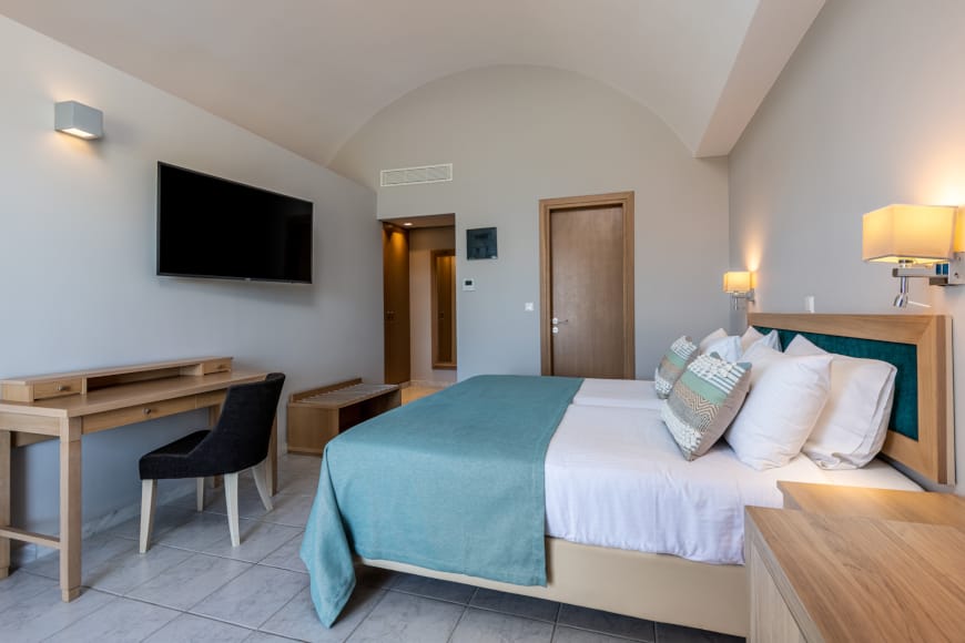 a hotel room with a bed and desk