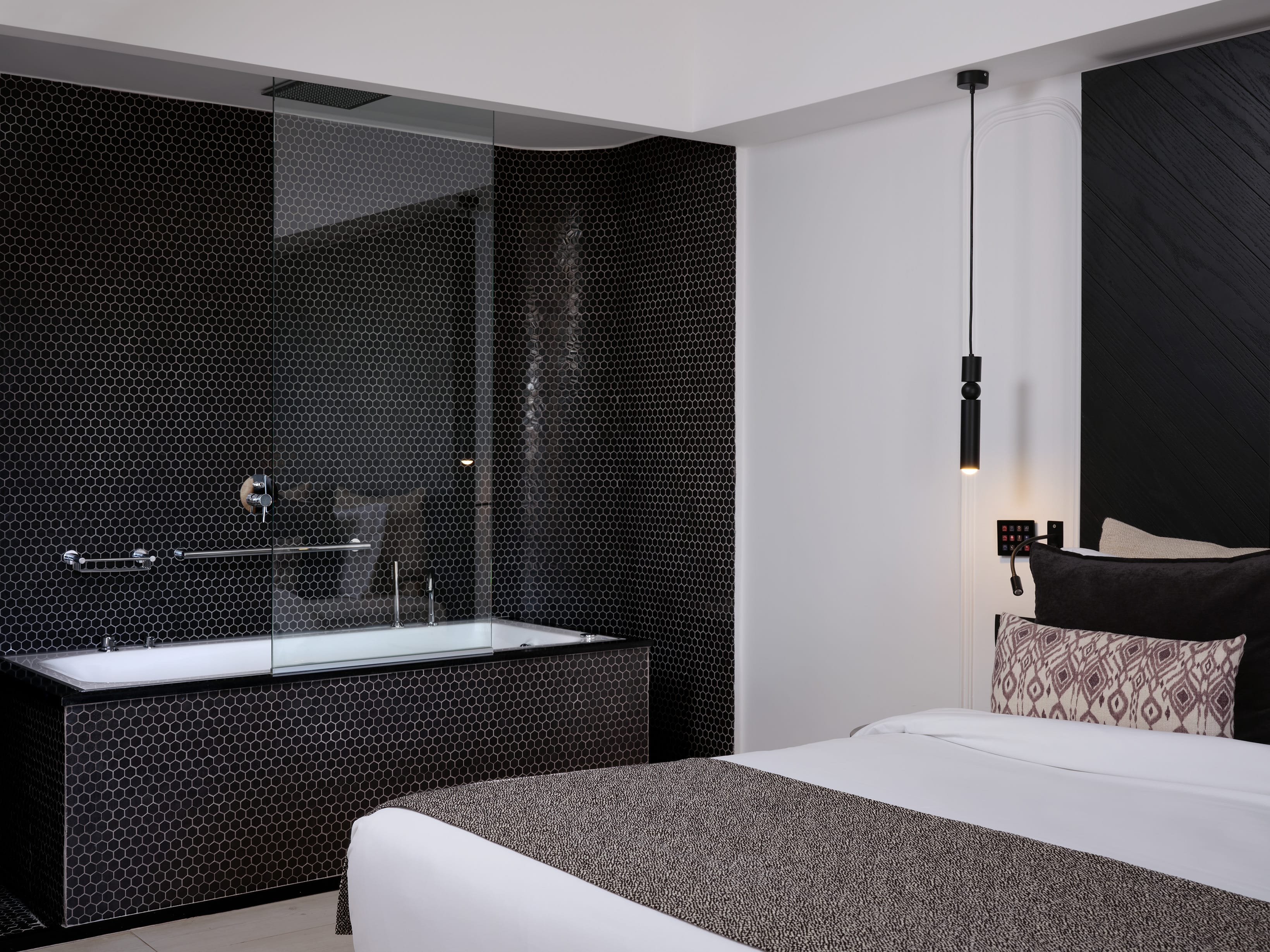 a bathroom with a large tub and a large mirror