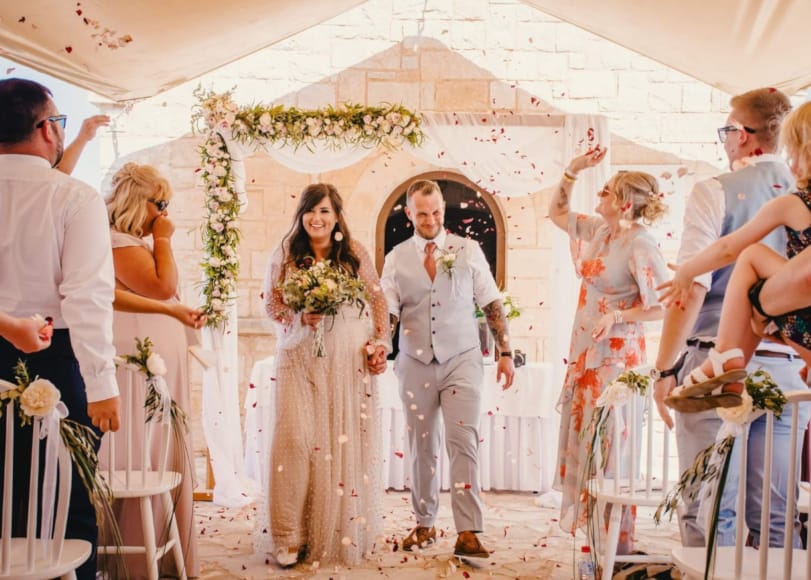 a man and woman walking down a aisle