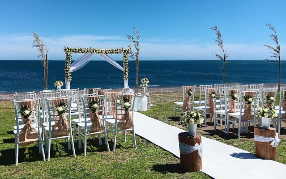 a set of tables and chairs on a beach