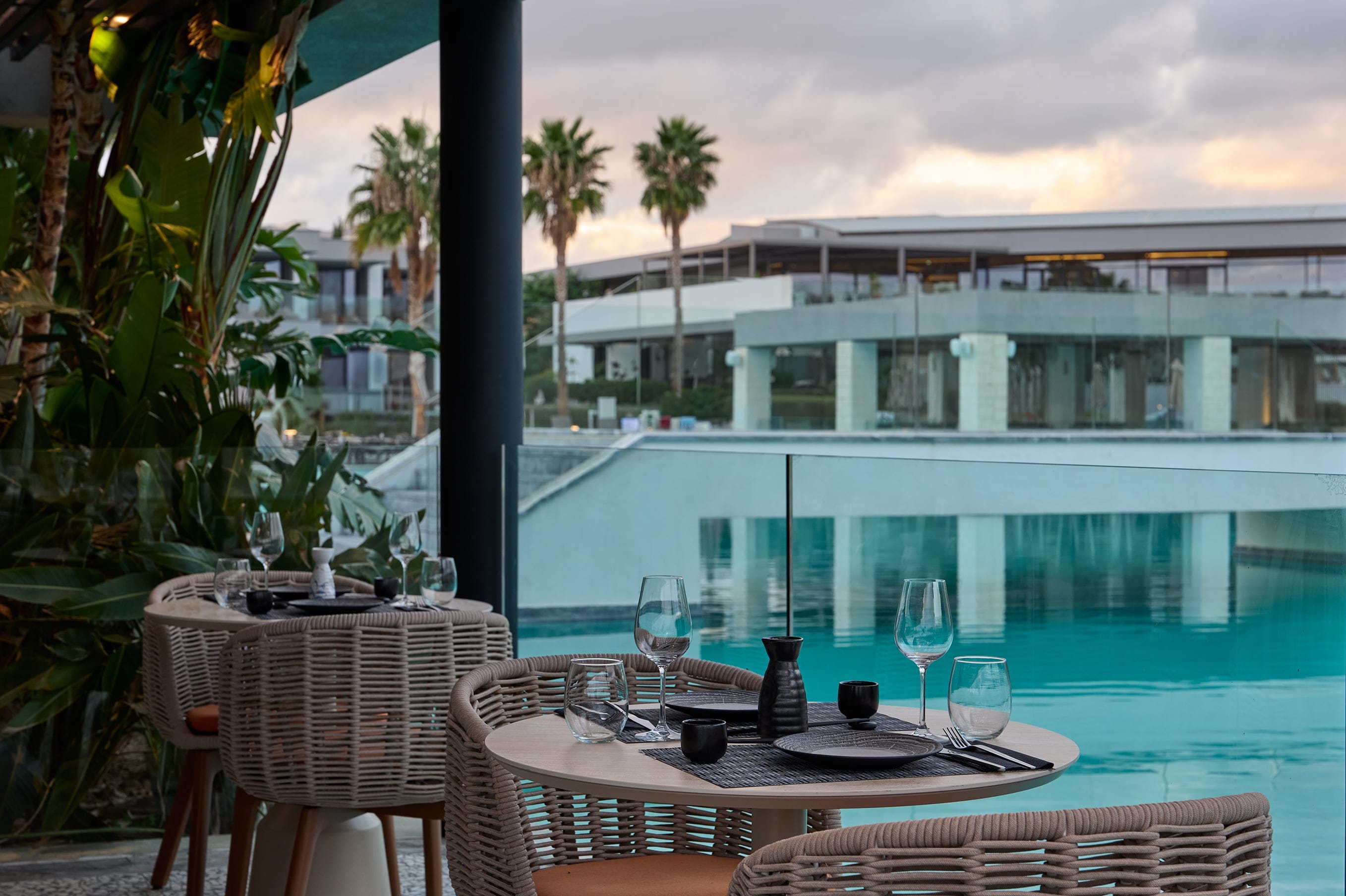 a table and chairs by a pool