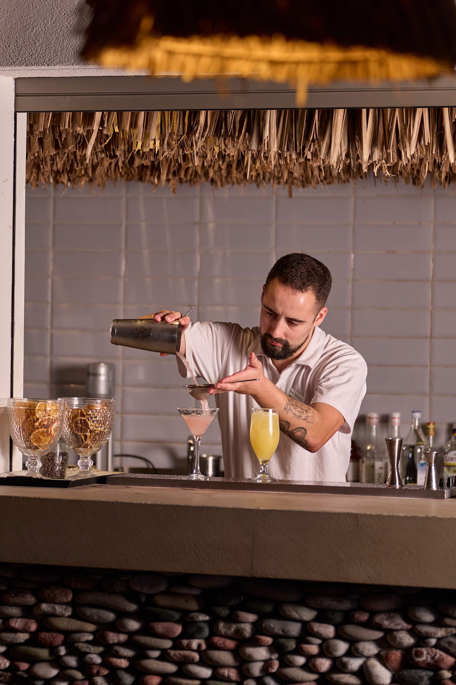 a man pouring a drink into a glass
