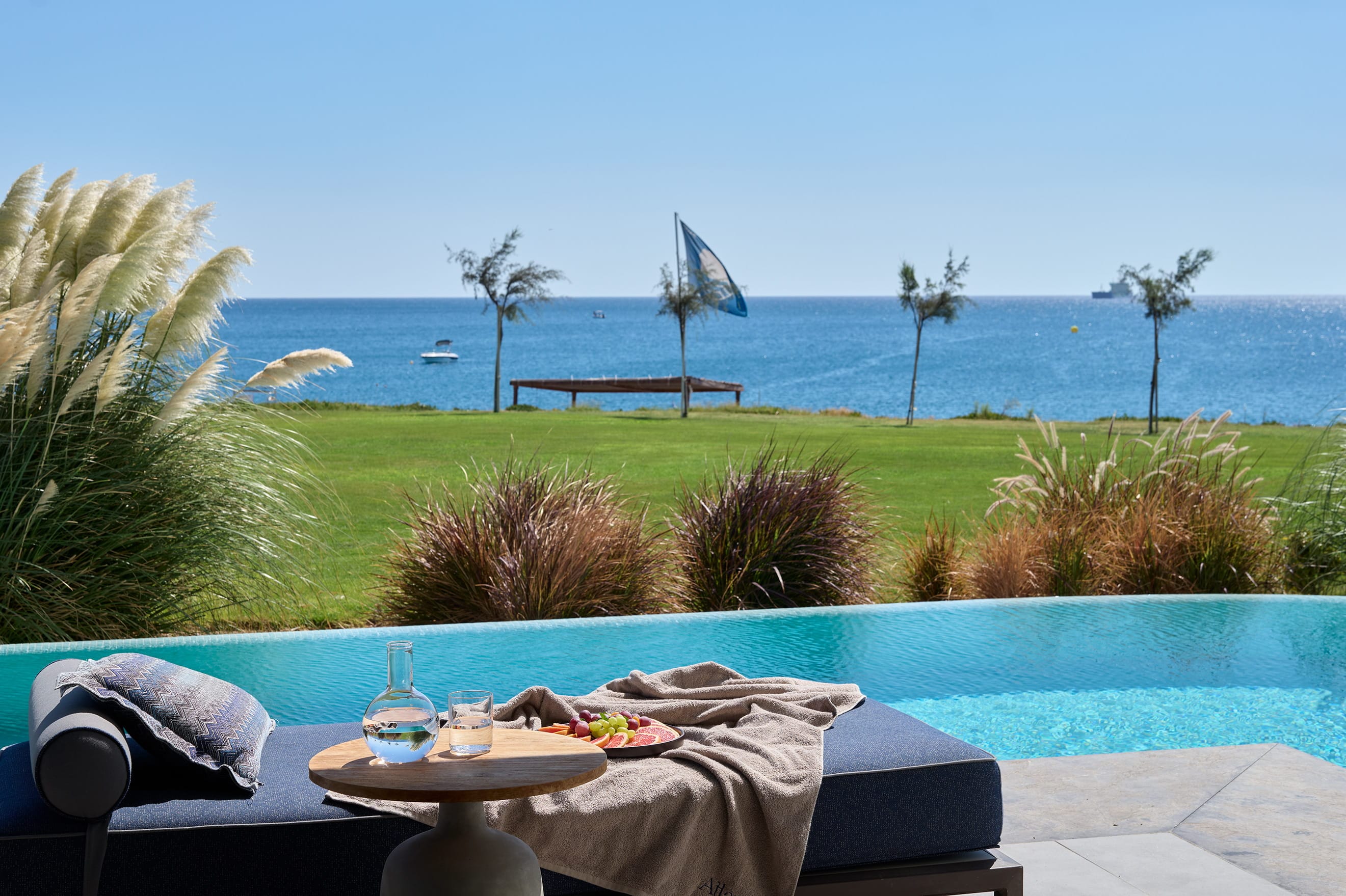 a table and chairs by a pool