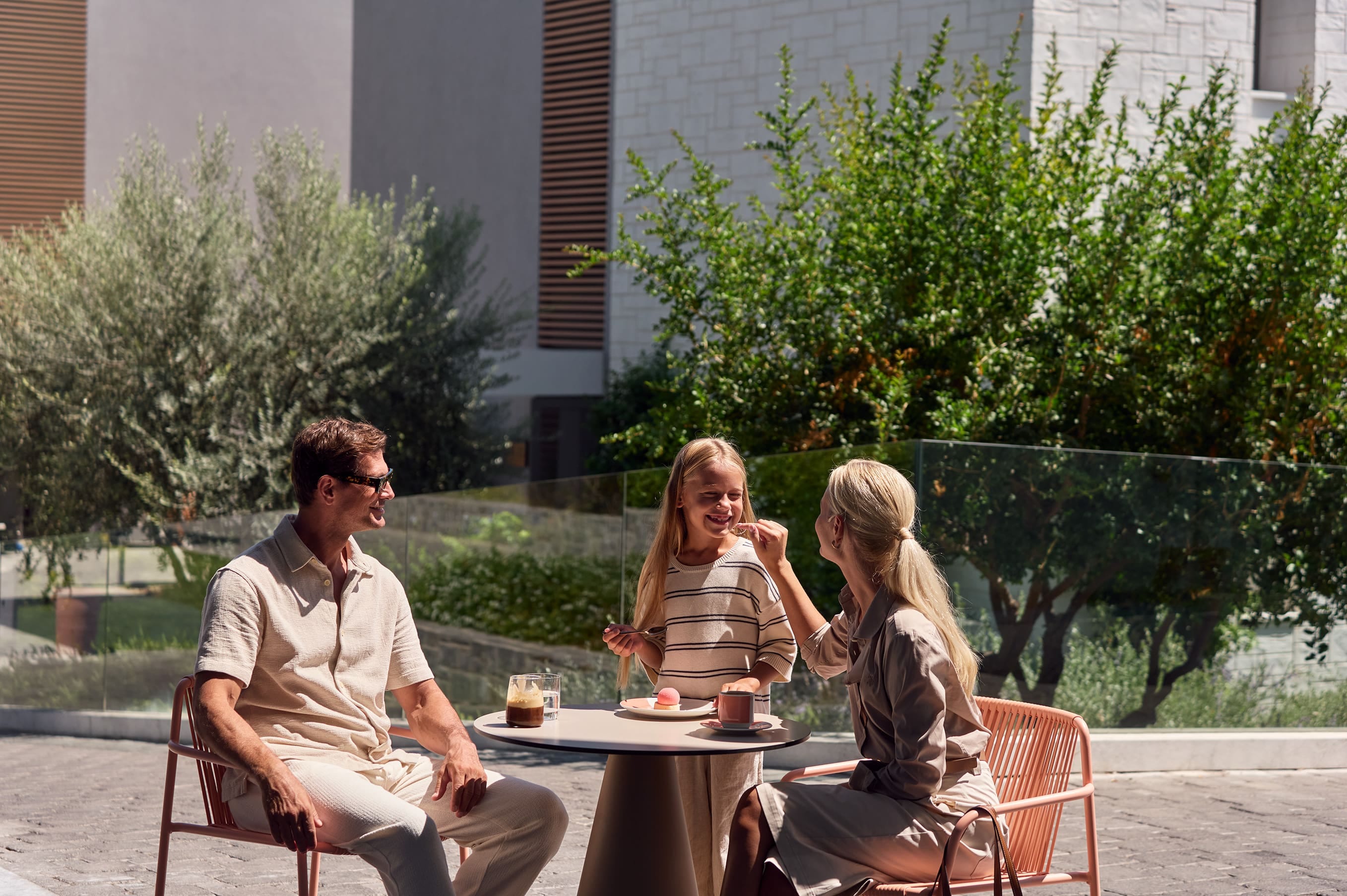 a group of people sitting at a table outside