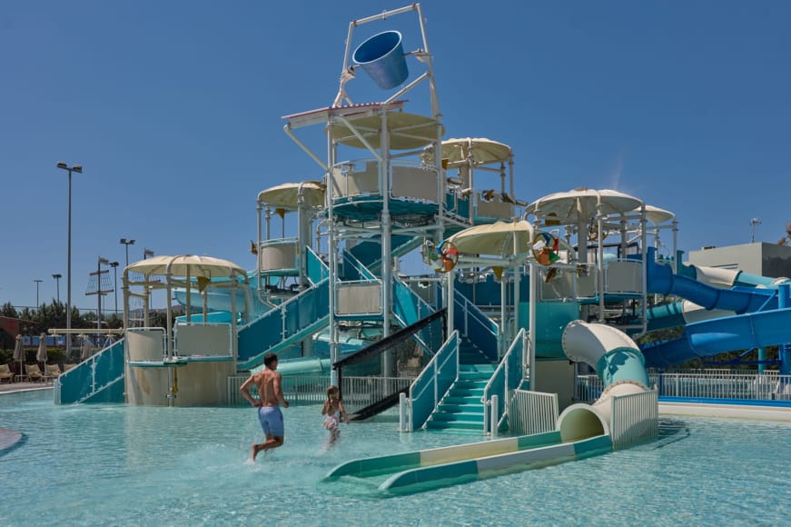 a person and a child playing in a water park