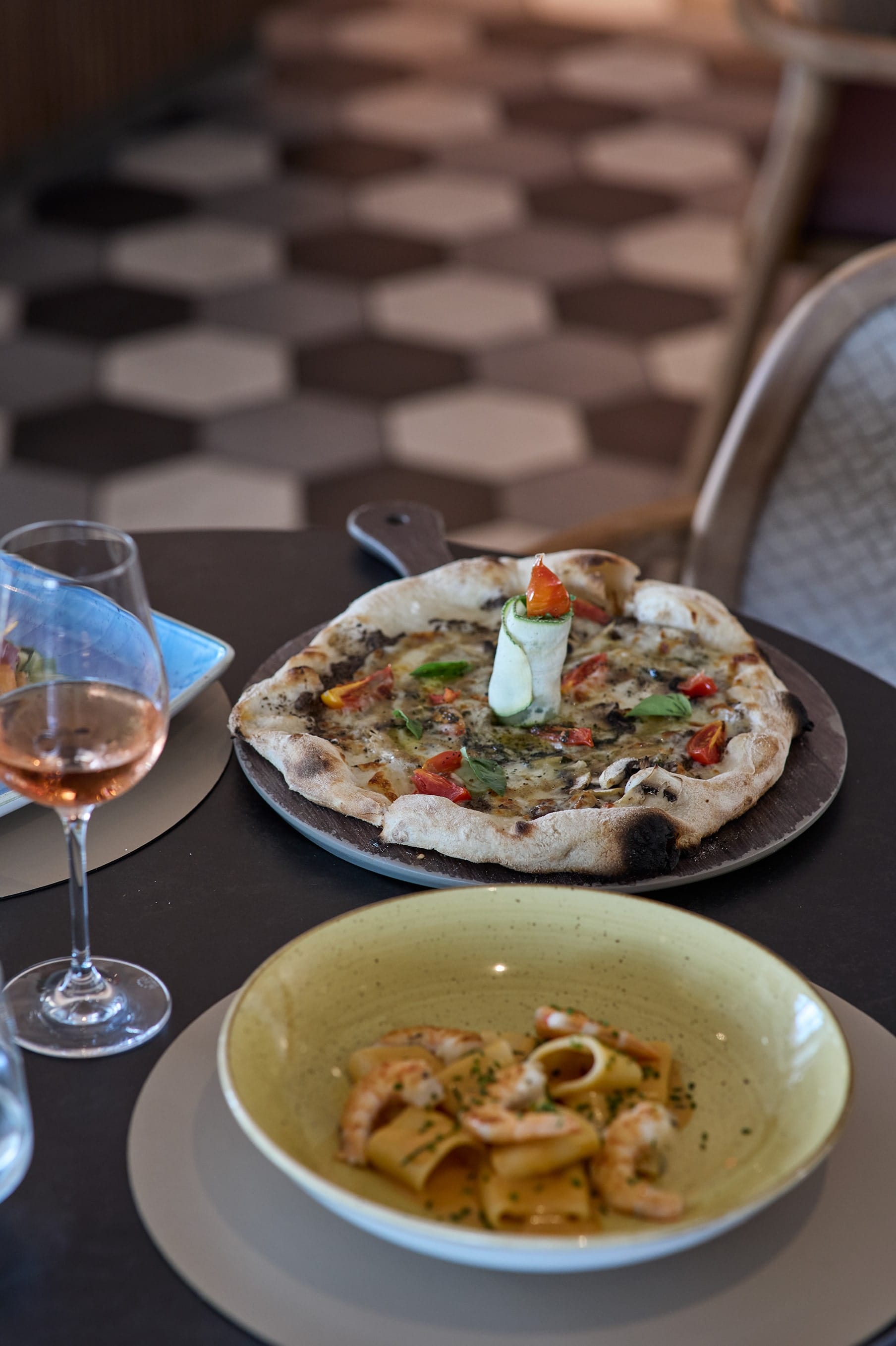 a plate of food and a glass of wine on a table