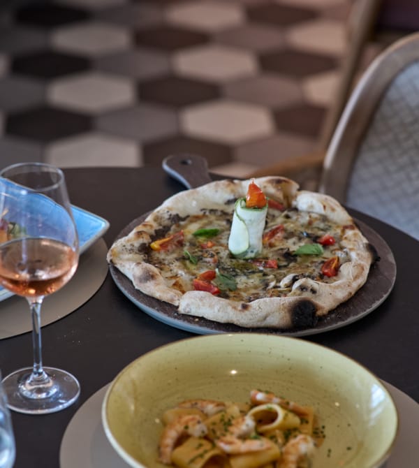 a plate of food and a glass of wine on a table