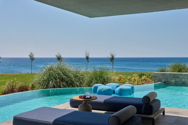 a pool with chairs and a table