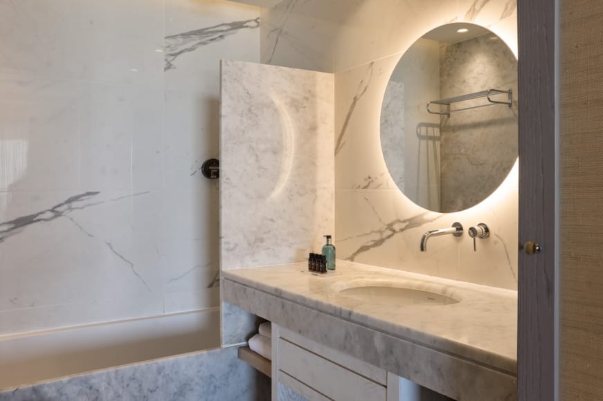 a bathroom with a round mirror