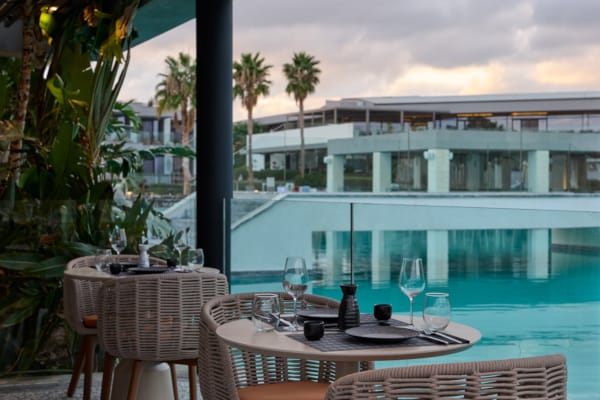 a table and chairs by a pool