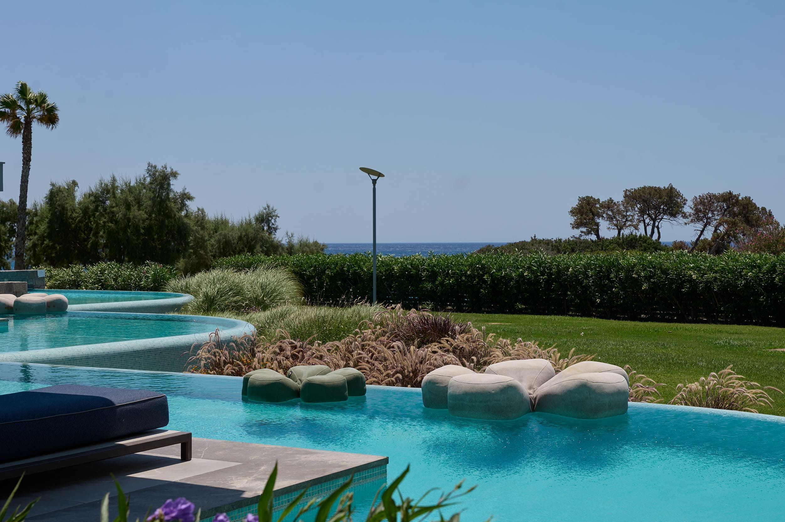 a pool with rocks and trees around it