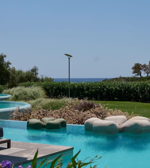 a pool with rocks and trees around it