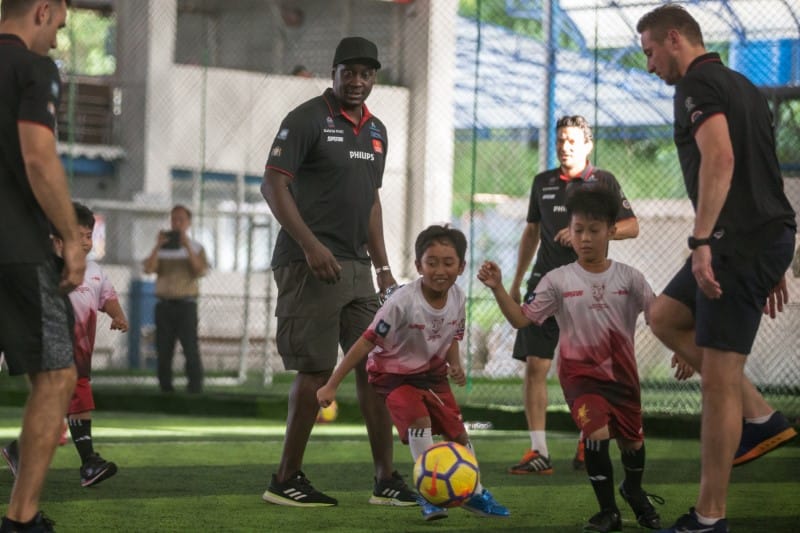 a group of kids playing football