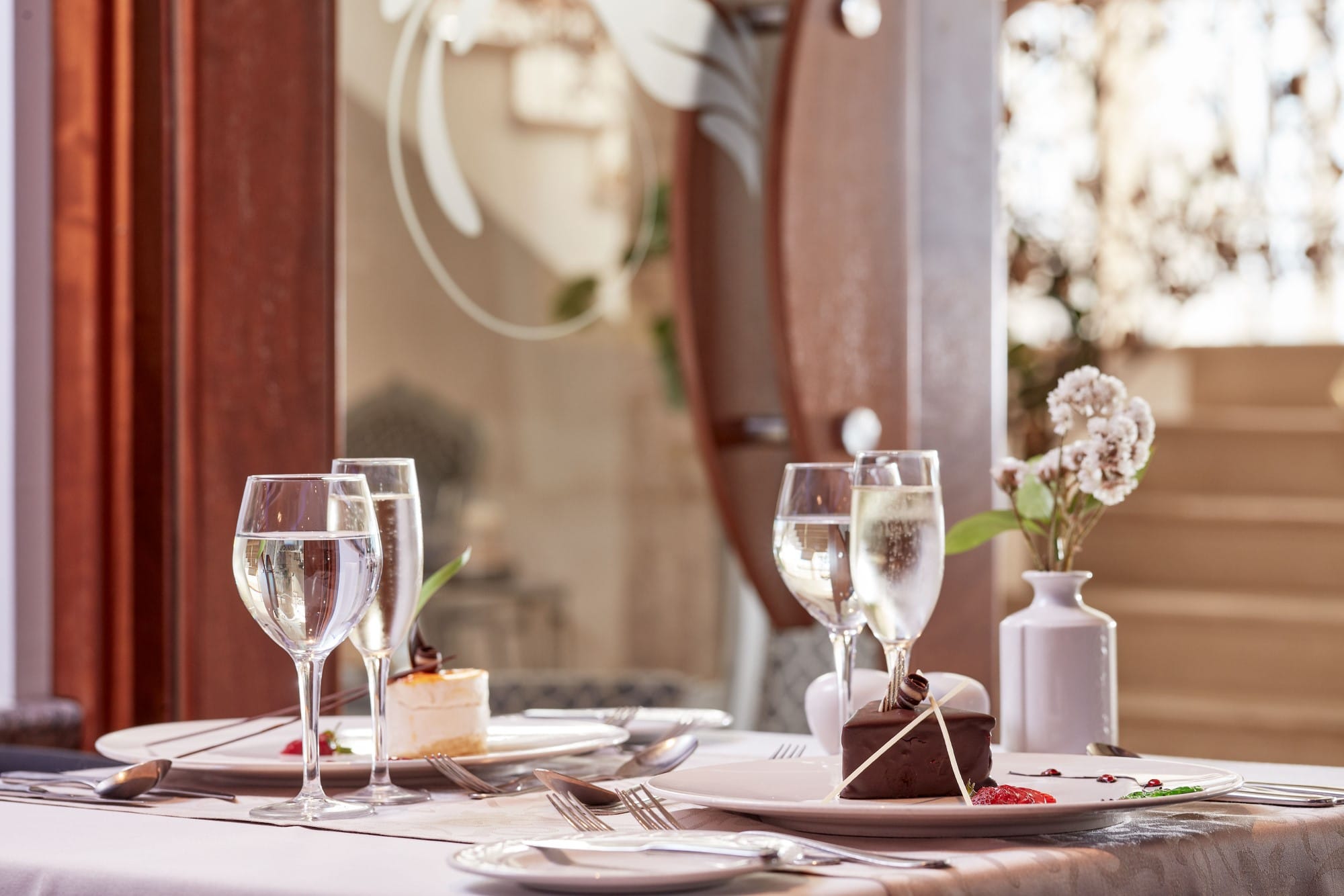 a table with glasses and plates
