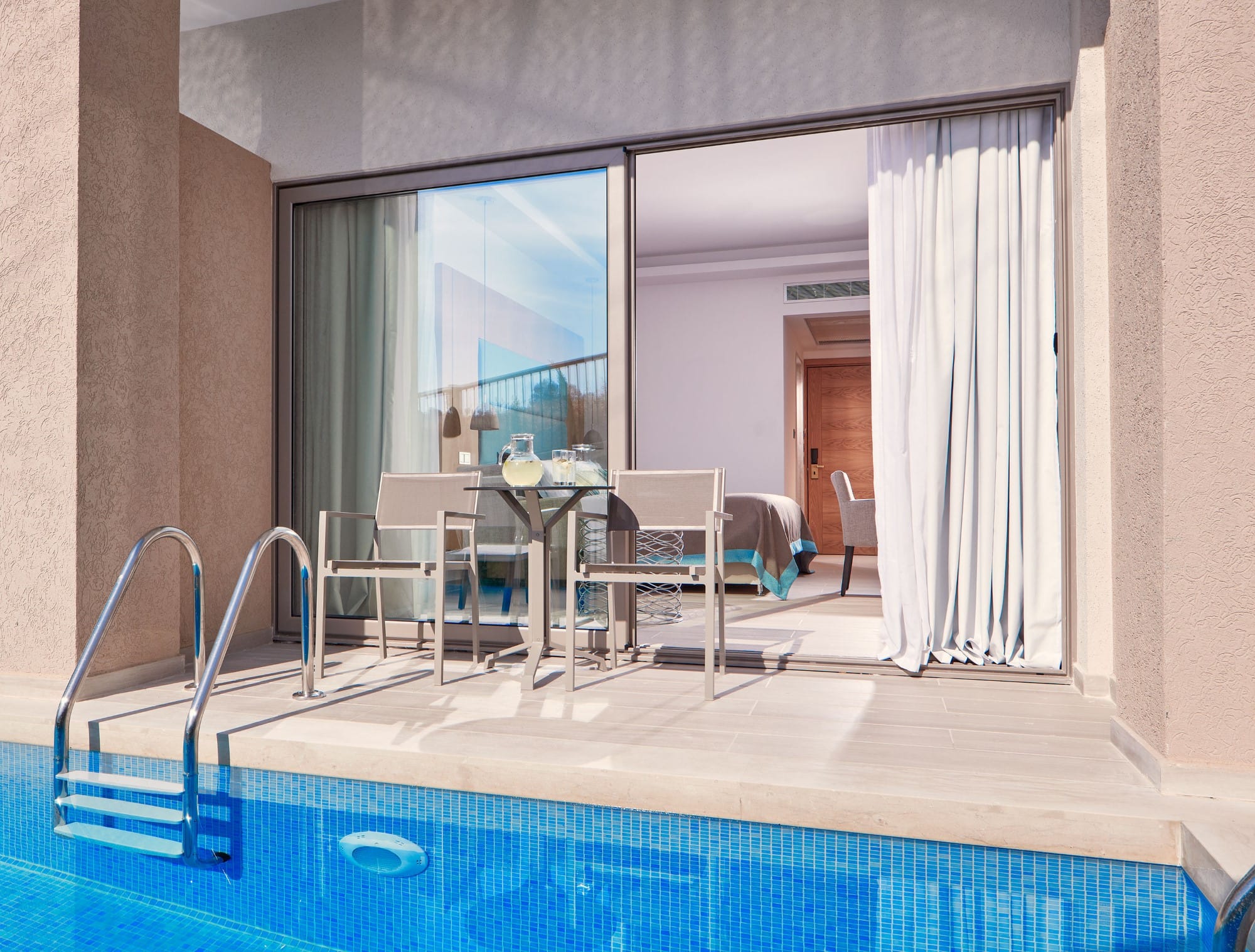 a swimming pool with a table and chairs