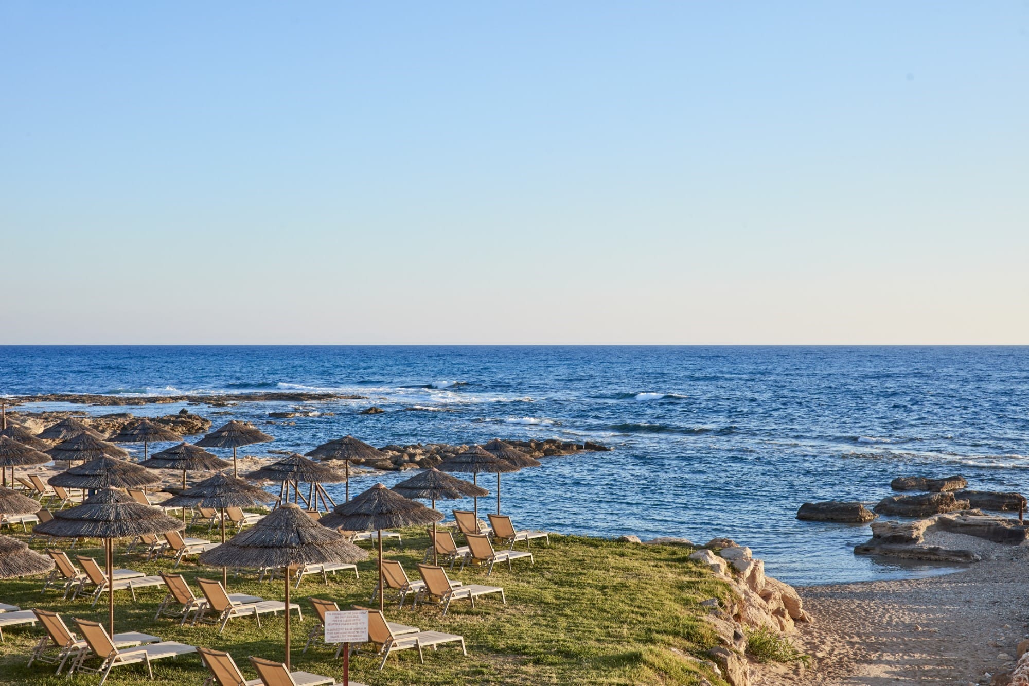 a beach with umbrellas and chairs
