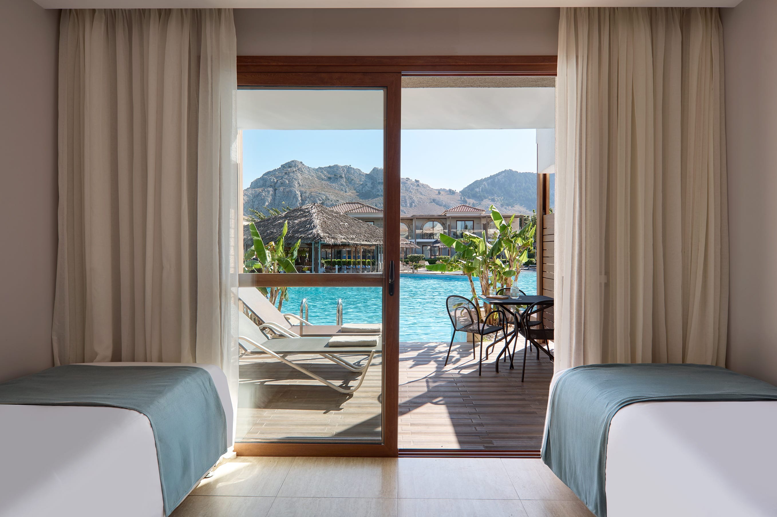 a room with a pool and a balcony