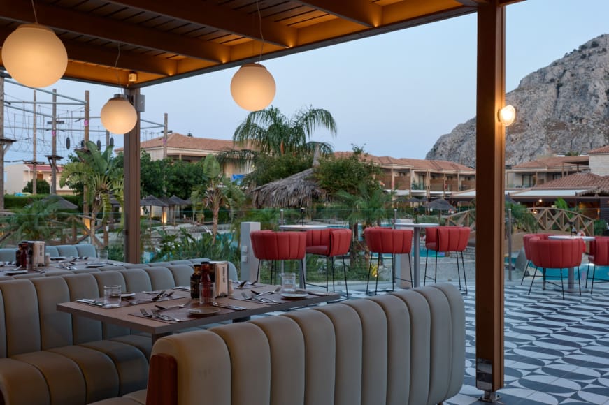 a table with chairs and a view of the ocean
