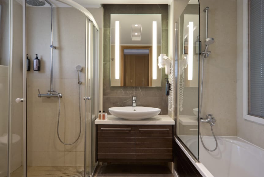 a bathroom with a sink and a shower unit