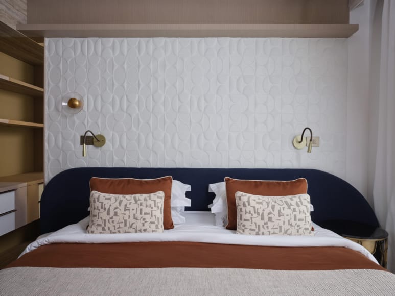 a bed with a blue pillow
