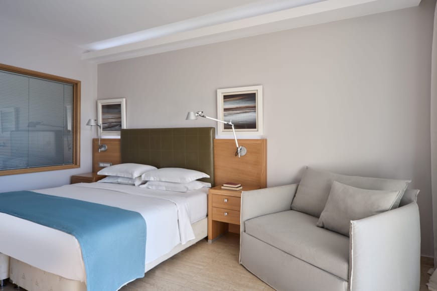 a bedroom with a bed and a couch