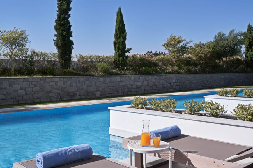 a pool with a table and chairs by it