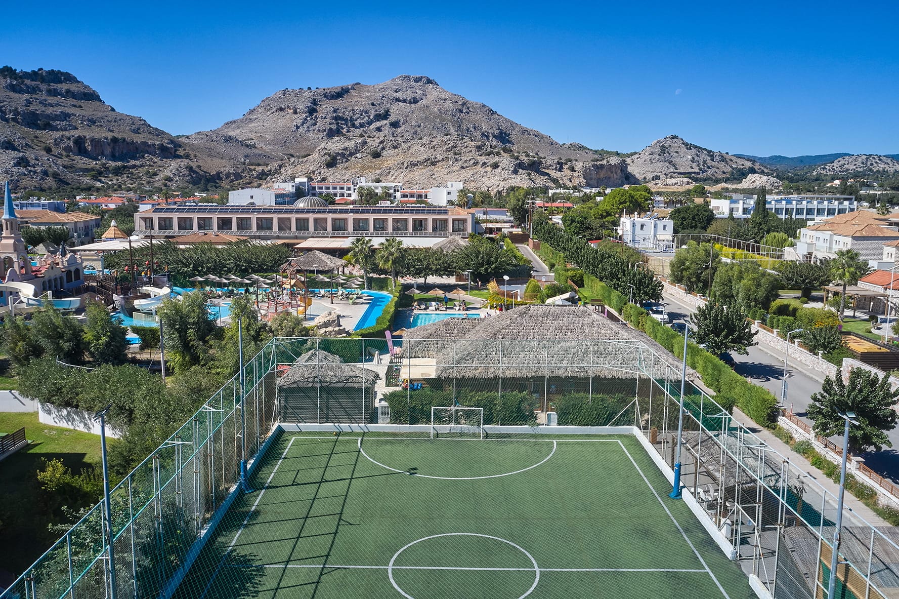 a tennis court with a mountain in the background