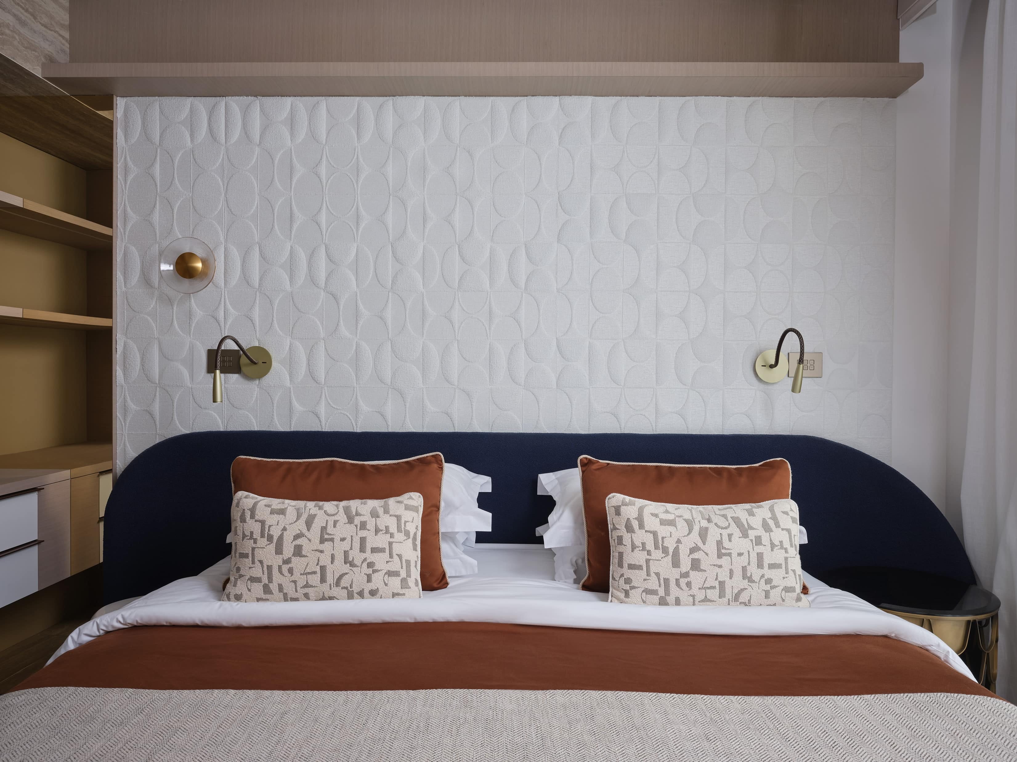 a bed with a blue pillow
