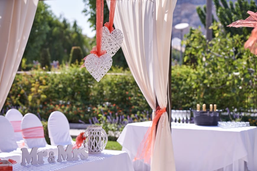 a table with white tables and white cloths and red and white cloths