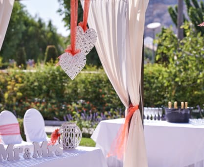 a table with white tables and white cloths and red and white cloths
