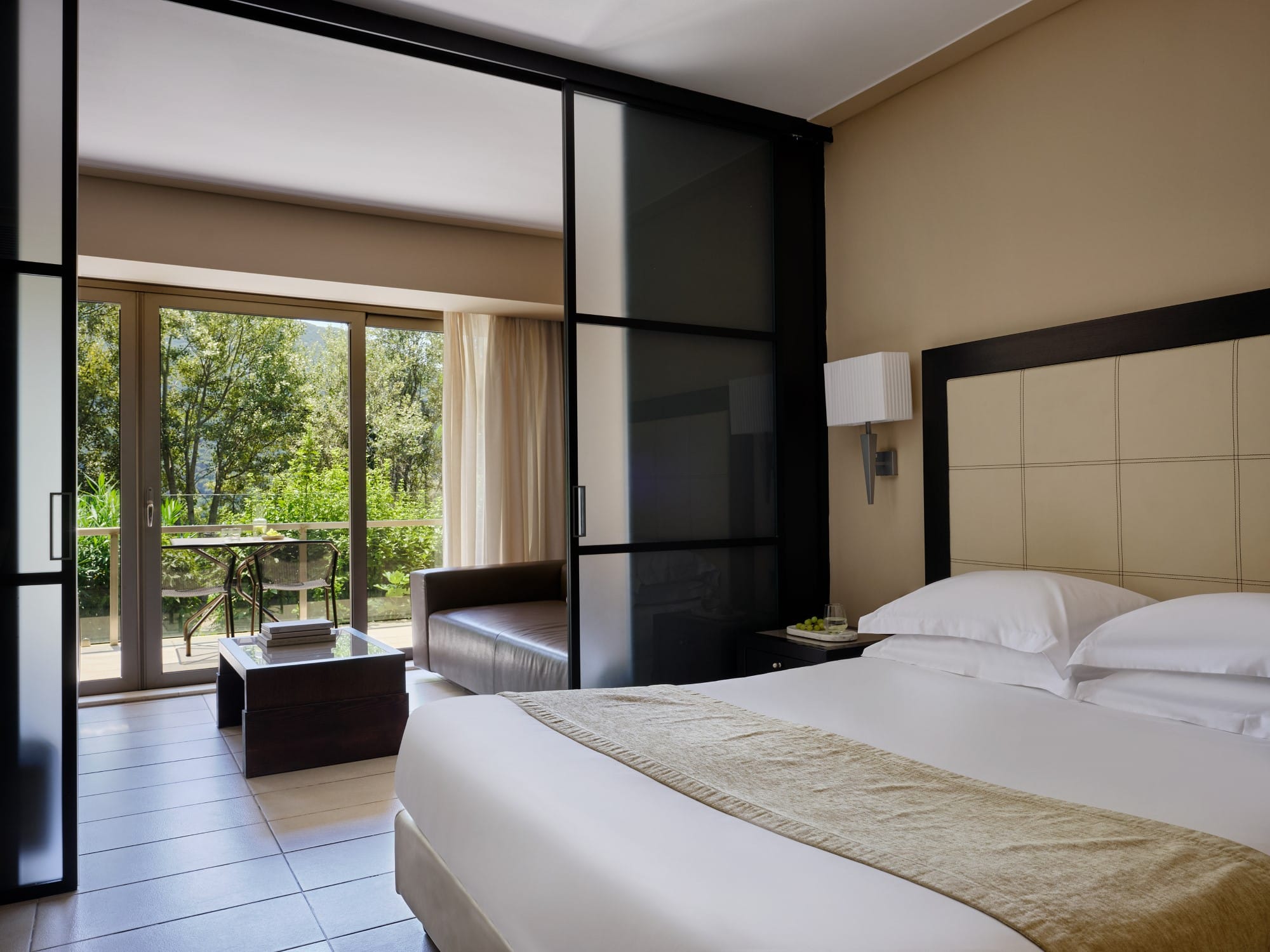 a bedroom with a large glass door