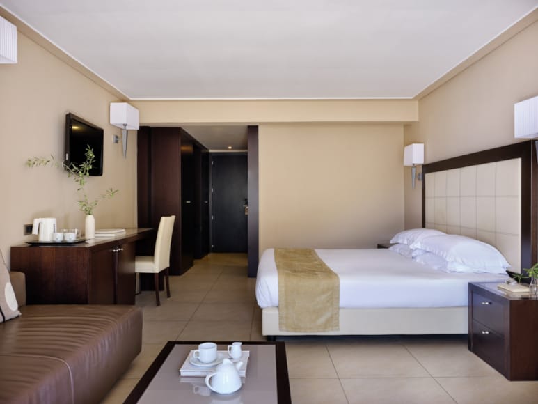 a hotel room with a bed and desk