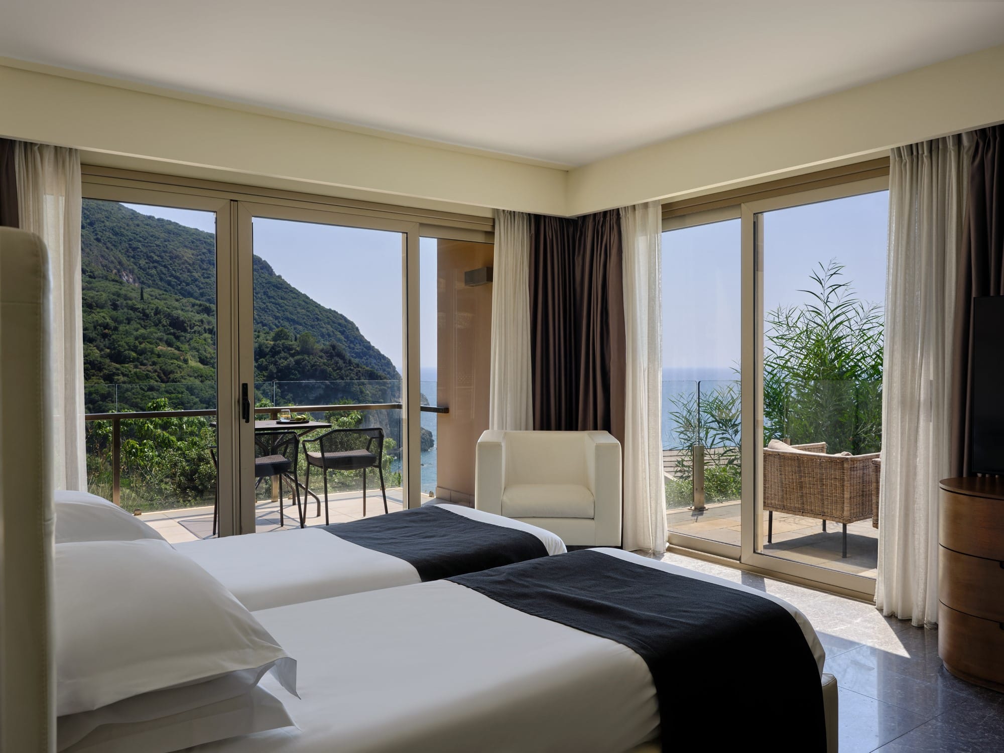 a room with a bed and a window with a view of the mountains