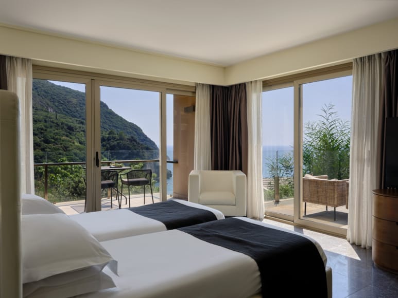 a room with a bed and a window with a view of the mountains